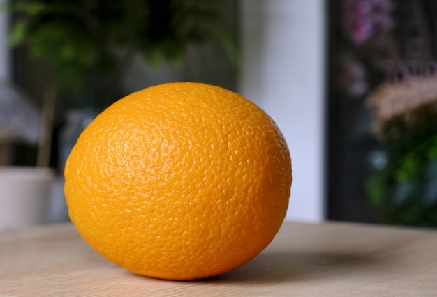 fresh bright tasty orange on a wooden table, natural vegan food.Close-up. Orange peel