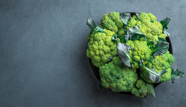 Fresh broccoli in a black plate on a graphite background Healthy food