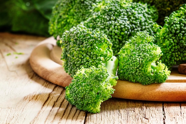 Fresh broccoli florets on a vintage wooden background selective focus