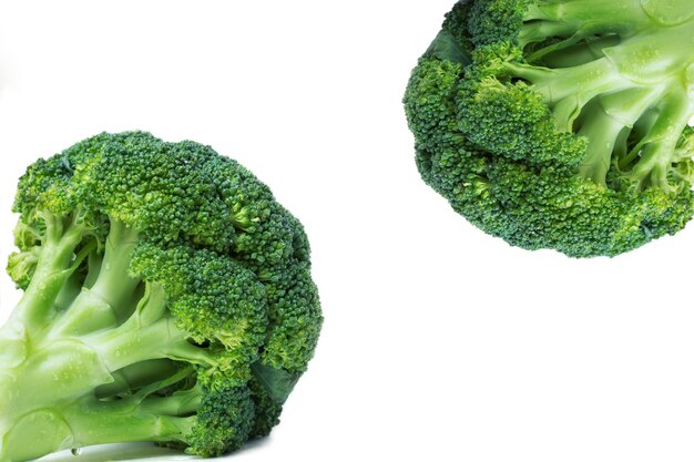 Fresh broccoli in two opposite corners, close-up, white background, isolate