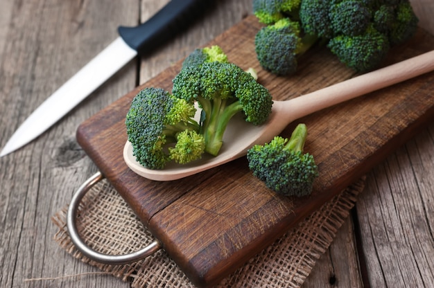 Fresh broccoli on wooden table close up