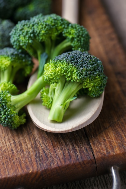 Fresh broccoli on wooden table close up