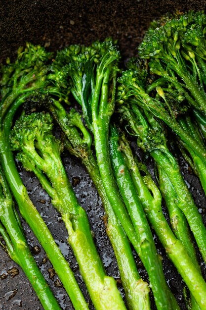 Fresh broccolini with nut powder baked close up