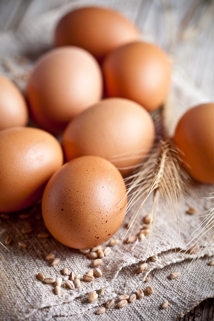  fresh brown eggs, wheat seads and ears 