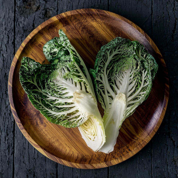 Fresh Brussel cabbage on a wooden plate On a rustic dark background