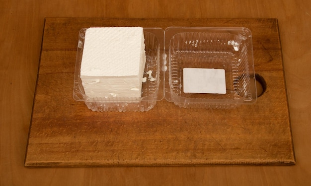 Fresh bulgarian cheese on wooden background in the kitchen