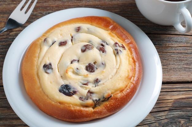 Fresh bun with cottage cheese and coffee