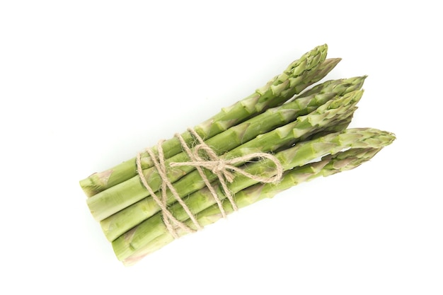 Fresh bunch of green asparagus tied with jute cord isolated on white background