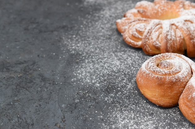 Fresh buns on the right side on a gray background.