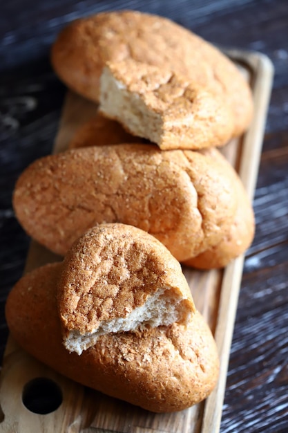 Fresh buns with bran on a wooden surface Wholemeal bread