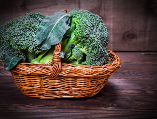 Fresh cabbage broccoli in a brown wicker basket 