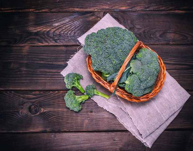 Fresh cabbage broccoli in a brown wicker basket 