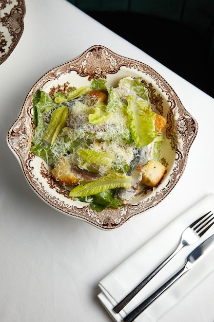 Fresh caesar salad with anchovies on a beautiful plate