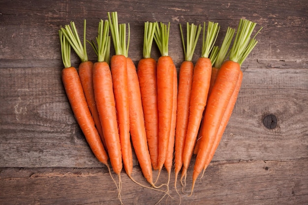 Fresh carrot bunch on grungy wooden background