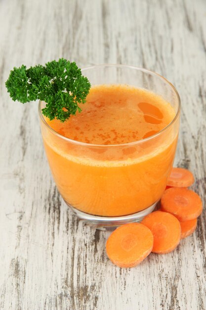 Fresh carrot juice on table closeup