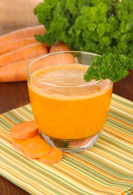 Fresh carrot juice on table closeup