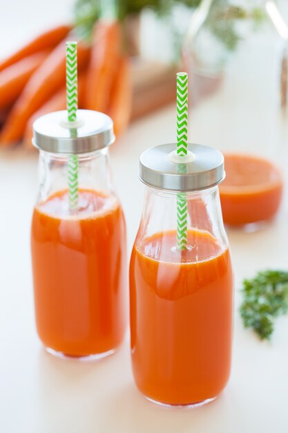 Fresh carrot juice and vegetables