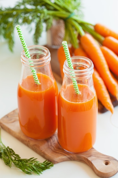 Fresh carrot juice and vegetables