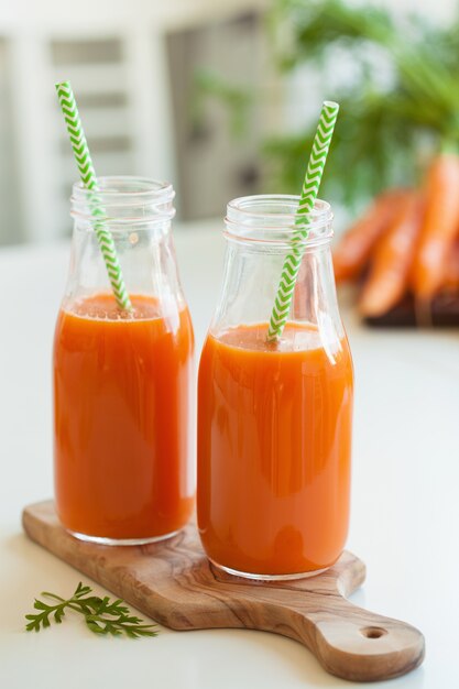 Fresh carrot juice and vegetables