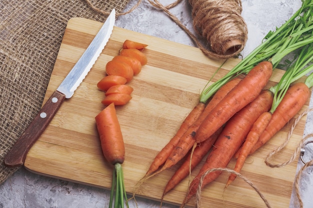 Fresh carrot sliced on a cutting board