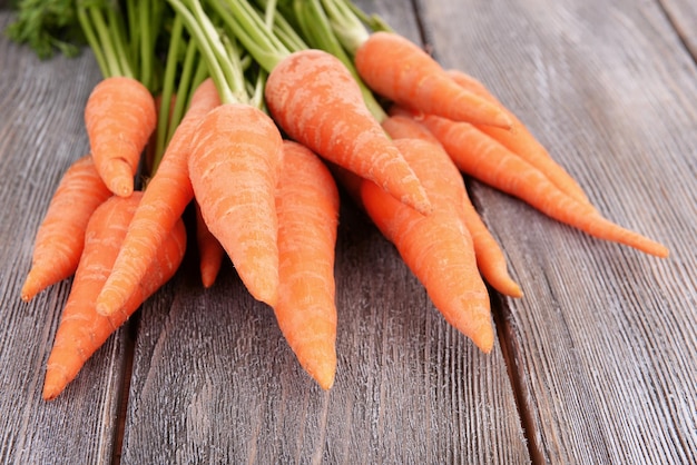 Fresh carrot on wooden background