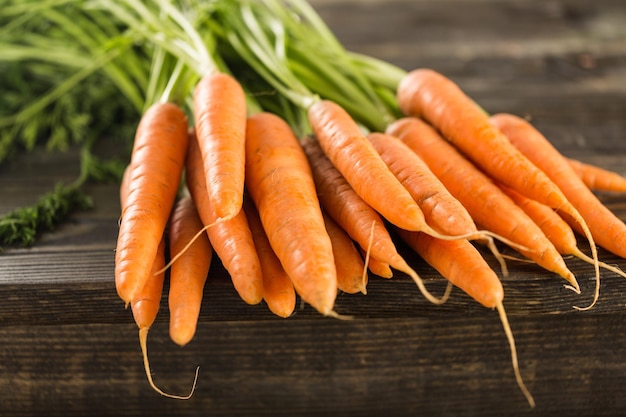 fresh carrot over wooden background