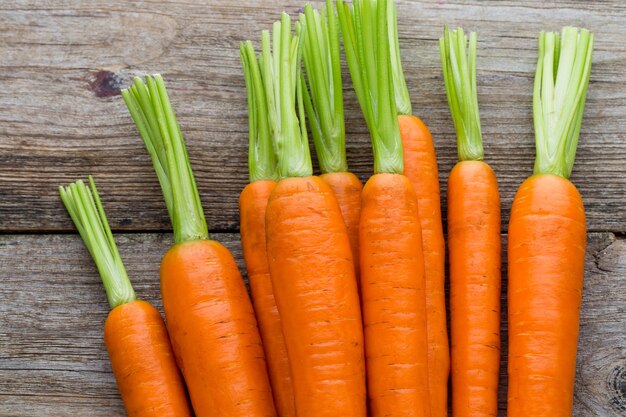 Fresh carrots bunch on rustic wooden background