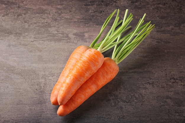 Fresh carrots on color surface