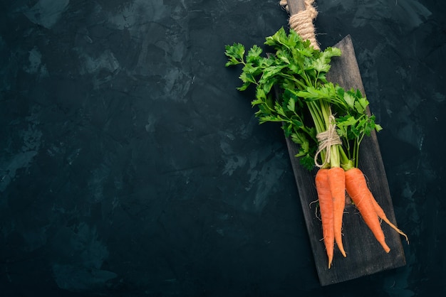 Fresh carrots Organic food On a black background Top view Free space for text