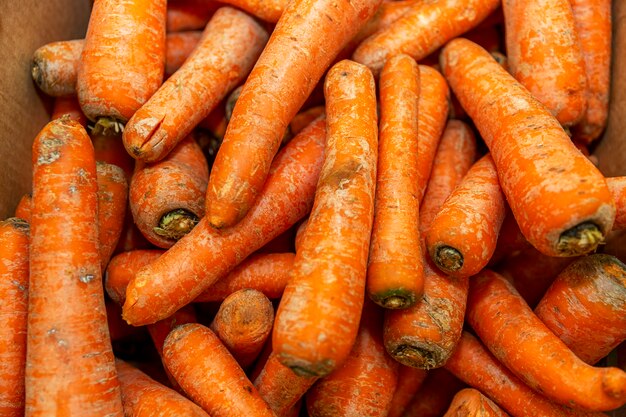 Fresh carrots on a store counter. Healthy nutrition and vitamins. Close-up.