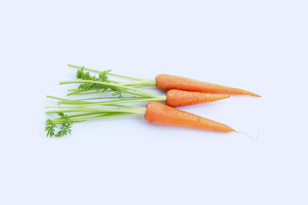 Fresh carrots on white surface