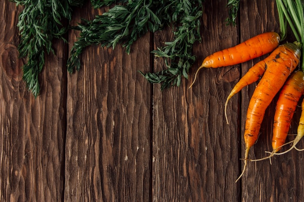 fresh carrots on a wooden background