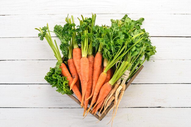 Fresh carrots in a wooden box On a wooden background Top view Copy space