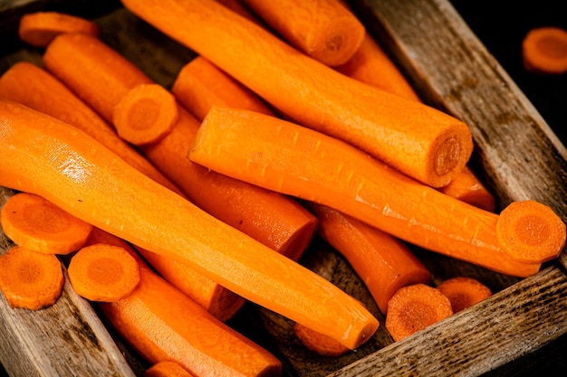 Fresh carrots on a wooden tray