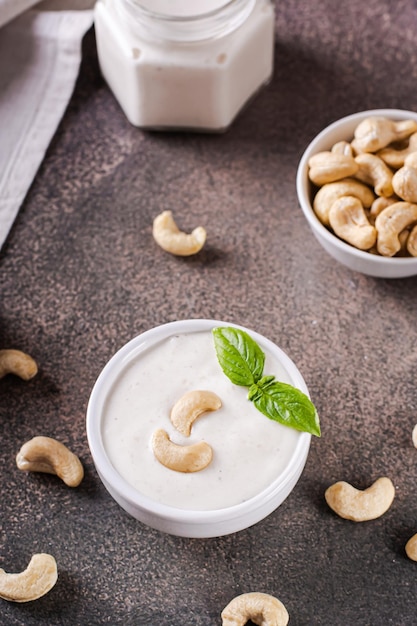 Fresh cashew sauce with basil in a bowl for a vegetarian diet vertical view