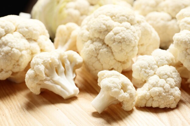 Fresh cauliflower close-up on a brown wooden table