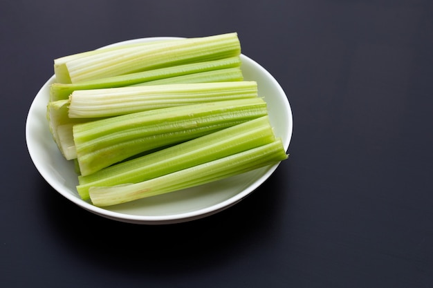 Fresh celery on dark surface. Copy space