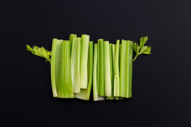 Fresh celery on dark surface.