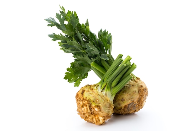 Fresh celery root with leaf isolated on white surface.