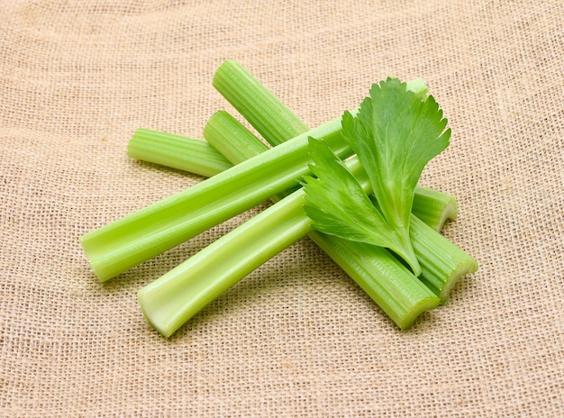 Fresh celery on rustic fabric background