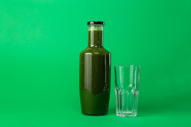 Fresh celery spinach juice in a glass bottle and an empty glass Healthy eating Detox juice diet