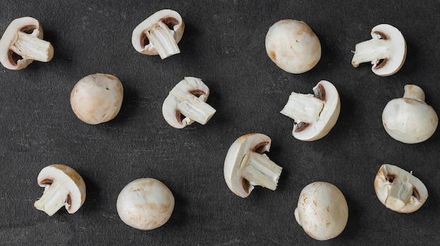 Fresh champignon mushrooms isolated on dark background