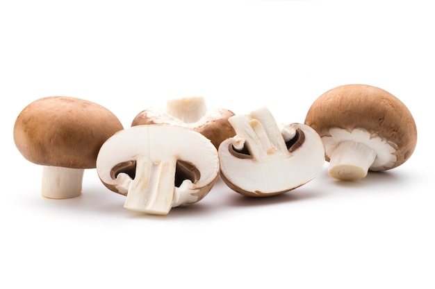 Fresh champignon mushrooms isolated on white.