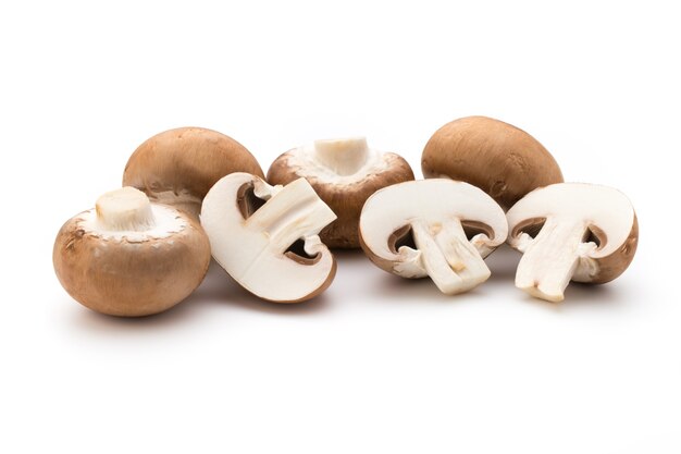 Fresh champignon mushrooms isolated on white.