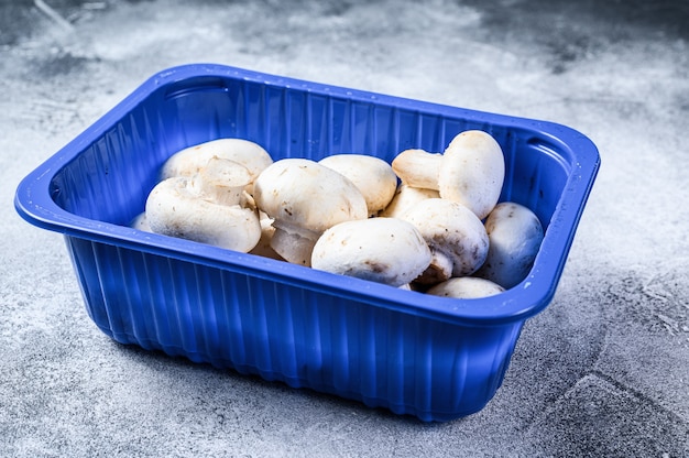 Fresh champignons in plastic packaging. 