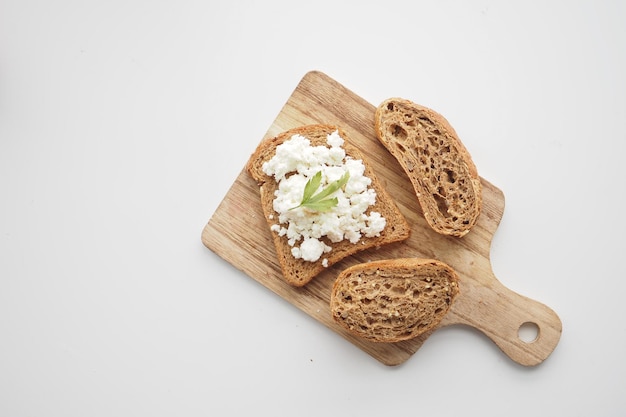 Fresh cheese on a bread with copy space top view