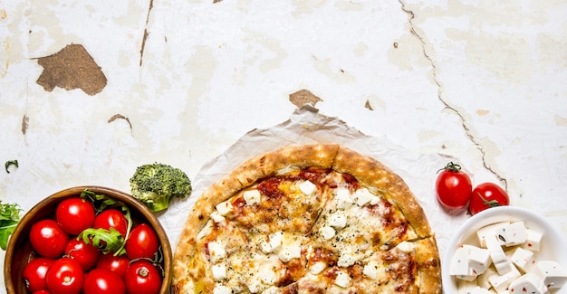 Fresh cheese pizza top view. On rustic table.