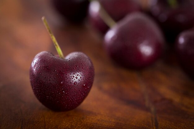 Fresh cherries on dark wooden background