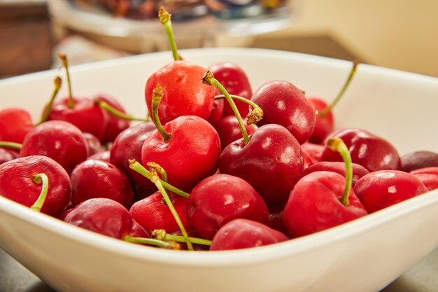 Fresh cherries in white plate, ready to eat.