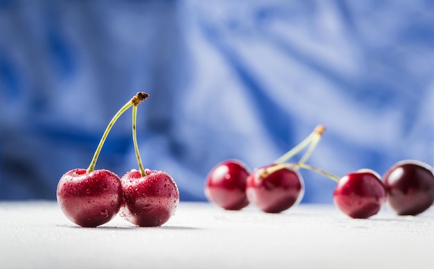 Fresh cherry berries on a blue background